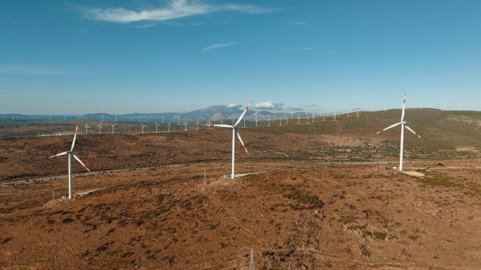 Wind turbines on a hillside under inspection